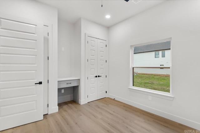 interior space with light hardwood / wood-style floors and multiple windows