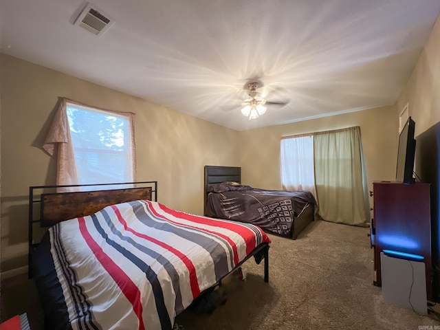 bedroom featuring carpet flooring, ceiling fan, and crown molding