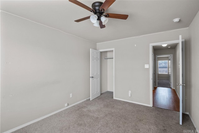 unfurnished bedroom featuring baseboards, a closet, a ceiling fan, and light colored carpet