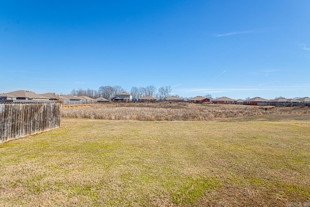 view of yard featuring a residential view and fence