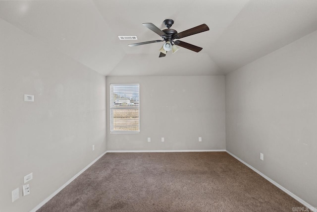 carpeted spare room with baseboards, visible vents, vaulted ceiling, and a ceiling fan