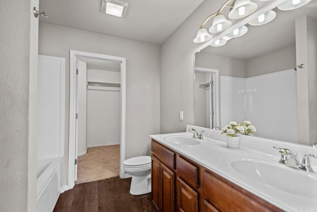 5900 Willow Way, Sherwood, AR 72117 - bathroom featuring double vanity, wood finished floors, and a shower