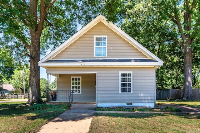 bungalow-style home with covered porch and a front lawn