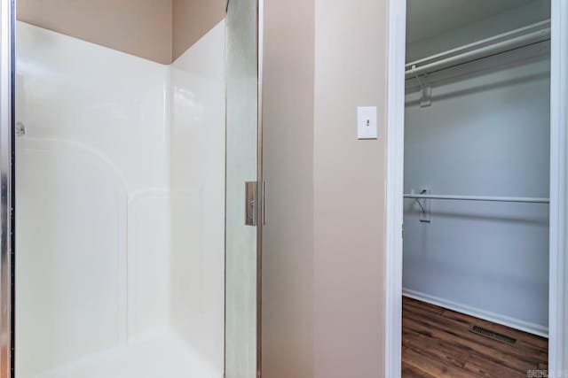 bathroom featuring walk in shower and hardwood / wood-style flooring