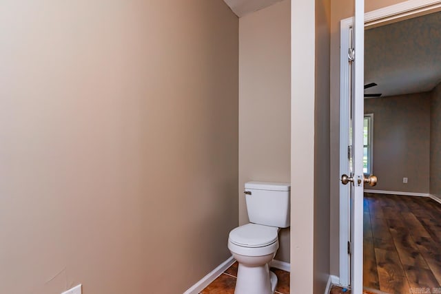 bathroom with hardwood / wood-style flooring and toilet