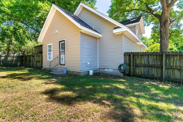 rear view of property featuring a yard