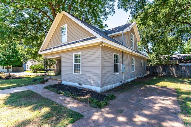 view of property exterior featuring a lawn and covered porch