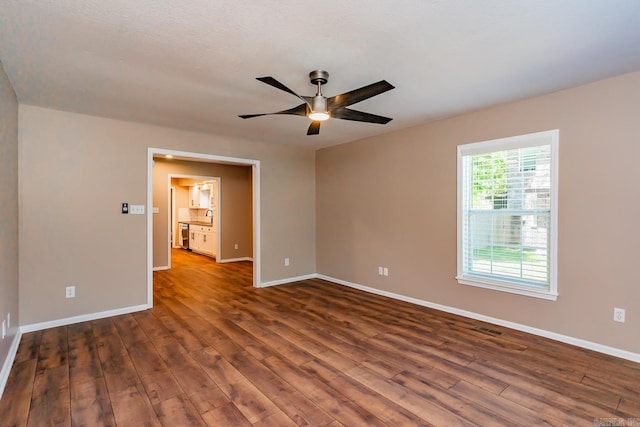 empty room with ceiling fan, dark hardwood / wood-style flooring, a textured ceiling, and sink