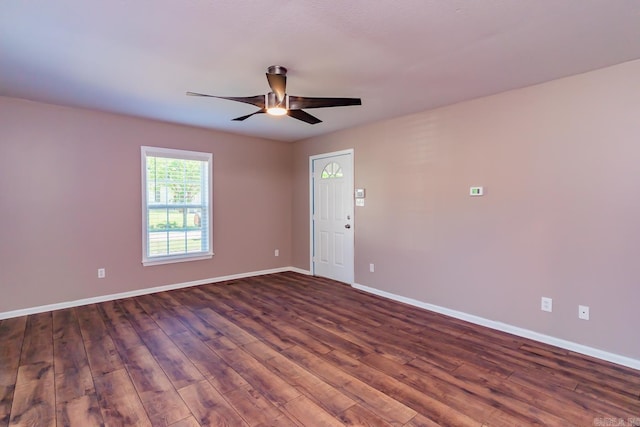 unfurnished room with ceiling fan and dark wood-type flooring