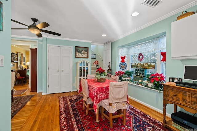 dining area with crown molding, light hardwood / wood-style flooring, and ceiling fan