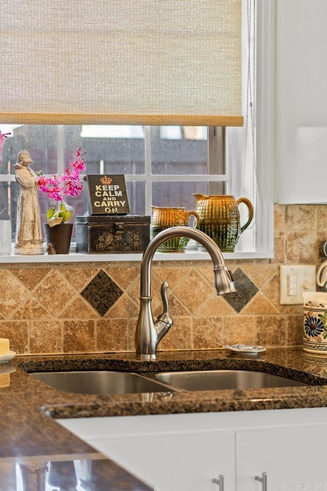 interior details featuring dark stone countertops and sink