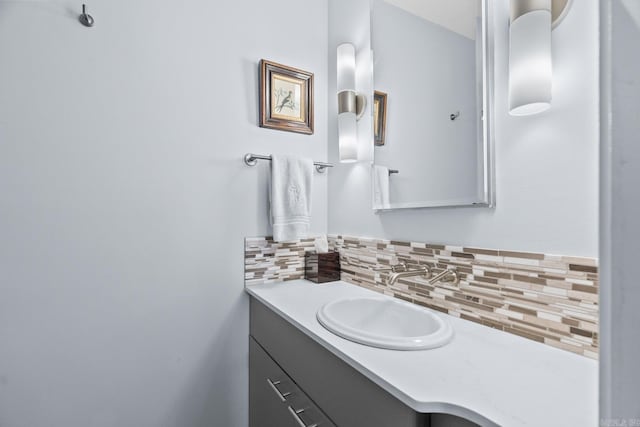 bathroom featuring vanity and tasteful backsplash