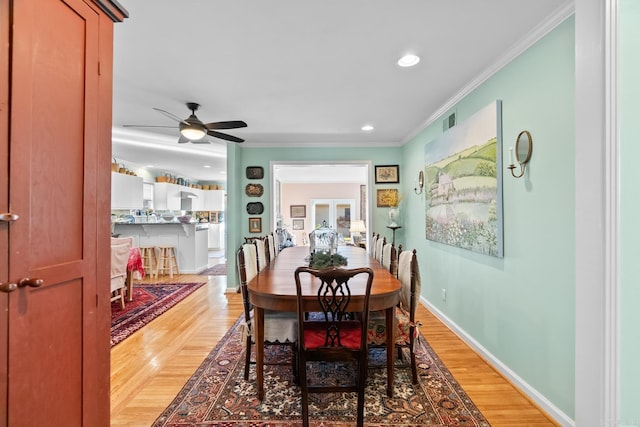 dining space featuring ceiling fan, wood-type flooring, and ornamental molding