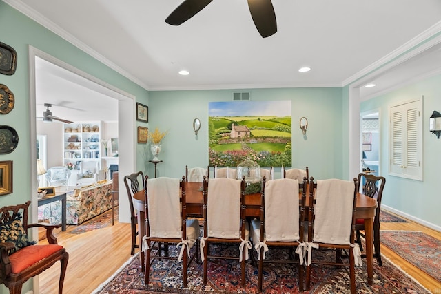 dining area featuring hardwood / wood-style flooring, ceiling fan, and ornamental molding