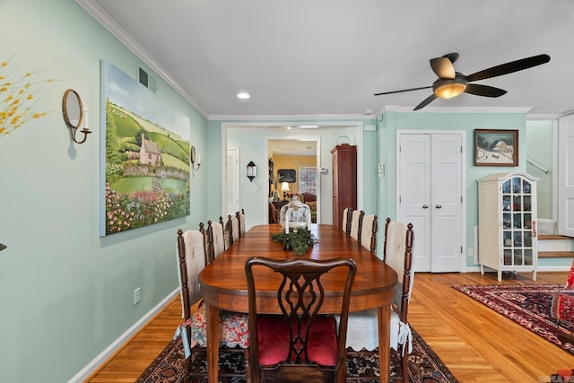 dining area with hardwood / wood-style floors, ceiling fan, and ornamental molding