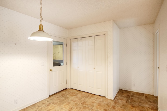 unfurnished bedroom with a closet and a textured ceiling