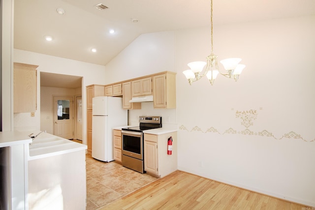 kitchen with light wood-type flooring, decorative light fixtures, a notable chandelier, white fridge, and stainless steel electric range