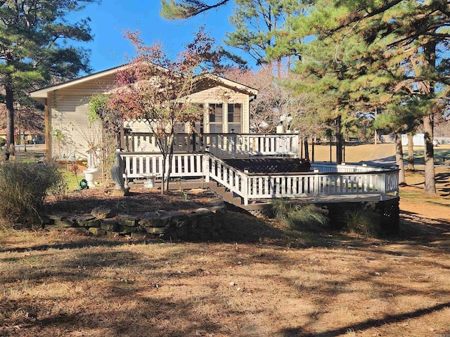 rear view of property with a wooden deck