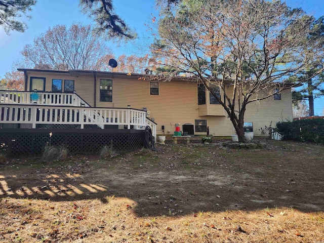 rear view of property with a wooden deck