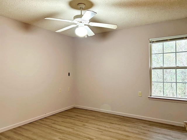 unfurnished room with a textured ceiling, light hardwood / wood-style flooring, and ceiling fan