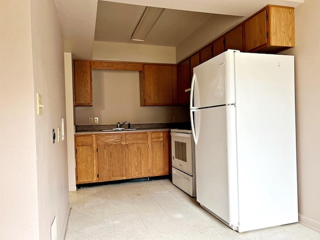 kitchen featuring white appliances and sink