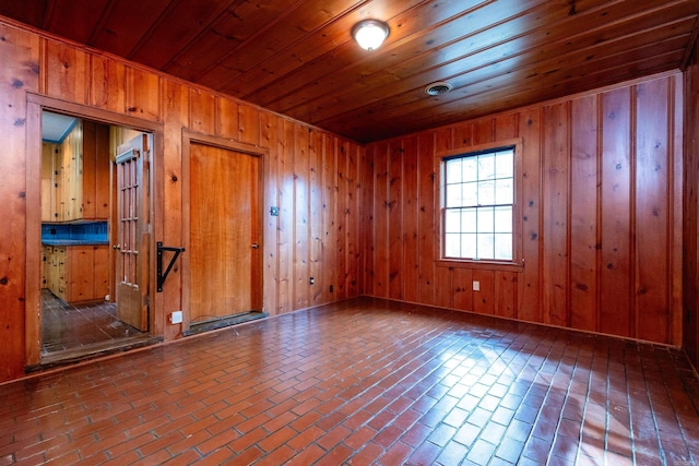 empty room featuring wooden walls and wood ceiling