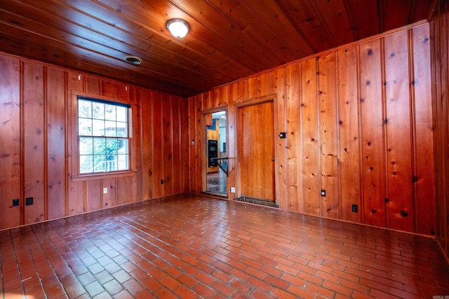 spare room with wooden walls and wooden ceiling