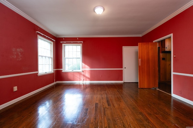 spare room featuring dark hardwood / wood-style flooring and ornamental molding