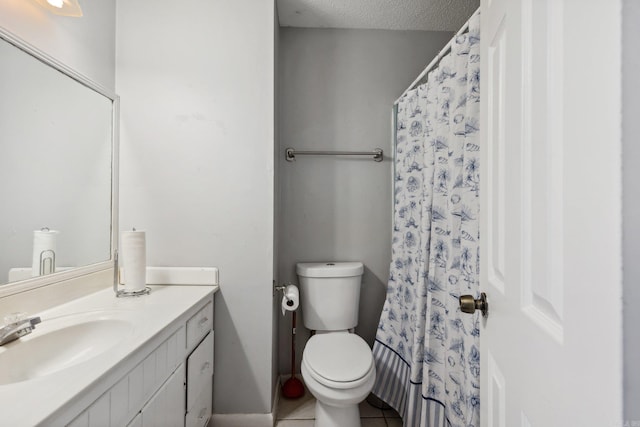 bathroom with vanity, tile patterned flooring, toilet, a textured ceiling, and curtained shower