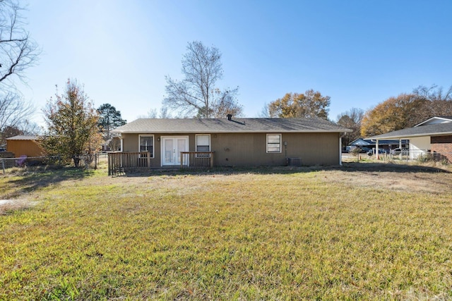 rear view of property with a yard and central AC unit