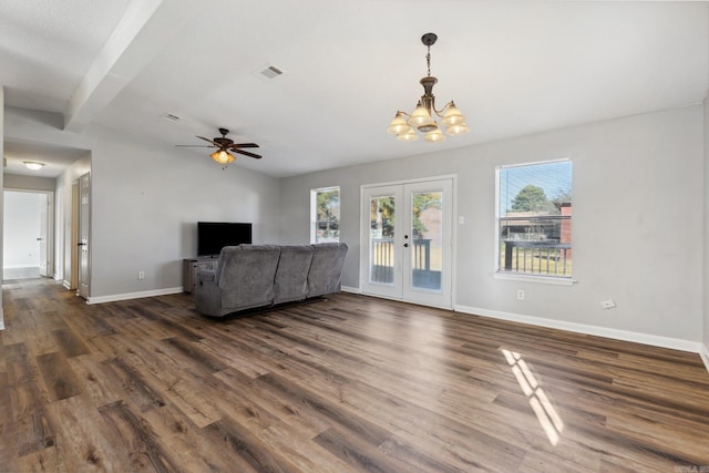 unfurnished living room with french doors, beamed ceiling, dark wood-type flooring, and ceiling fan with notable chandelier