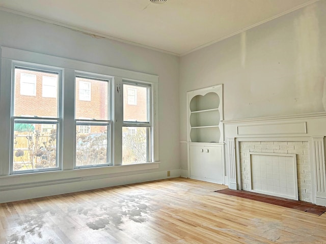 unfurnished living room featuring a fireplace, light hardwood / wood-style flooring, and crown molding