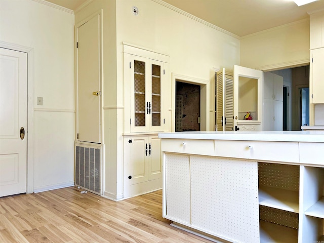 bathroom with hardwood / wood-style flooring and crown molding