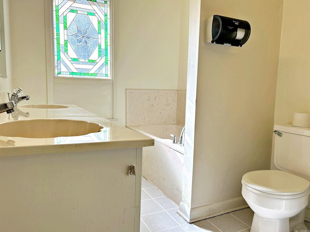 bathroom with tile patterned flooring, vanity, toilet, and a tub