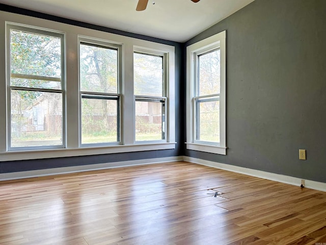 unfurnished room featuring ceiling fan, lofted ceiling, and light hardwood / wood-style flooring