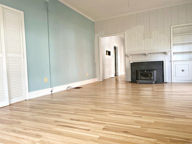 unfurnished living room featuring crown molding and light hardwood / wood-style flooring