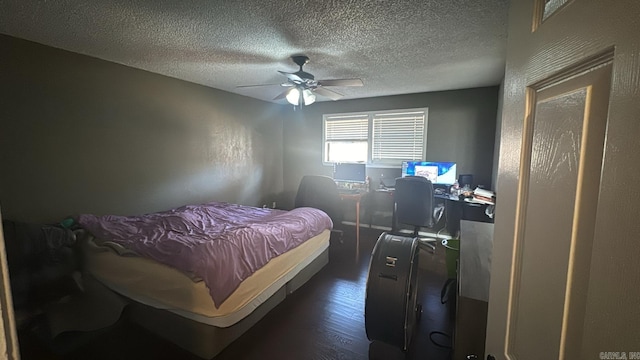 bedroom featuring ceiling fan, dark hardwood / wood-style floors, and a textured ceiling