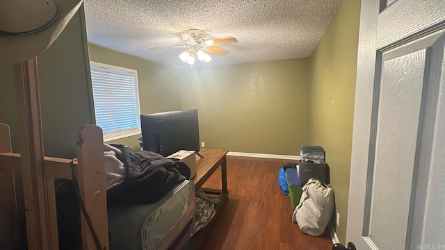 bedroom with wood-type flooring, a textured ceiling, and ceiling fan