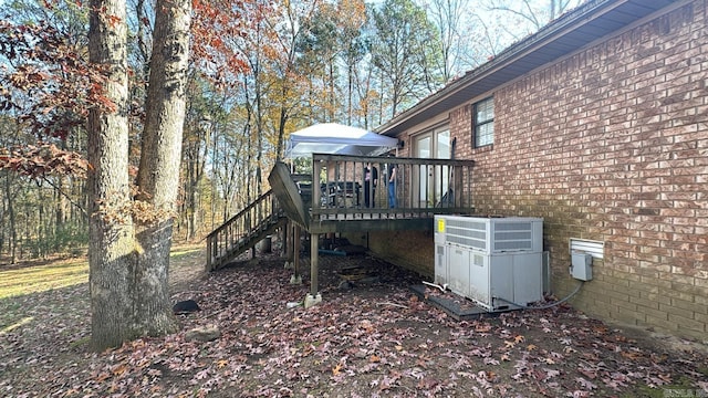 view of yard featuring central AC and a deck