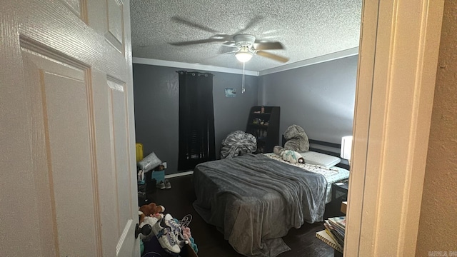 bedroom featuring a textured ceiling, ceiling fan, and crown molding