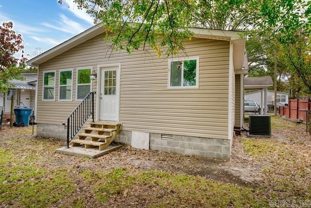 rear view of property with central AC unit