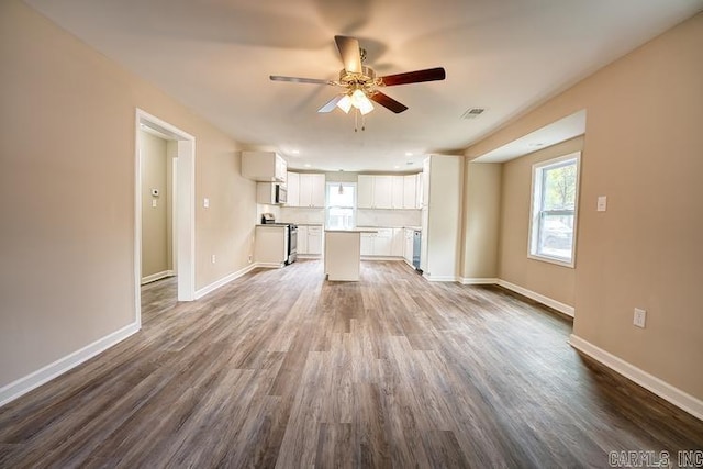 unfurnished living room with hardwood / wood-style flooring and ceiling fan