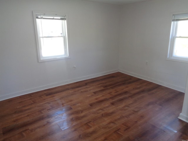 spare room with dark hardwood / wood-style floors