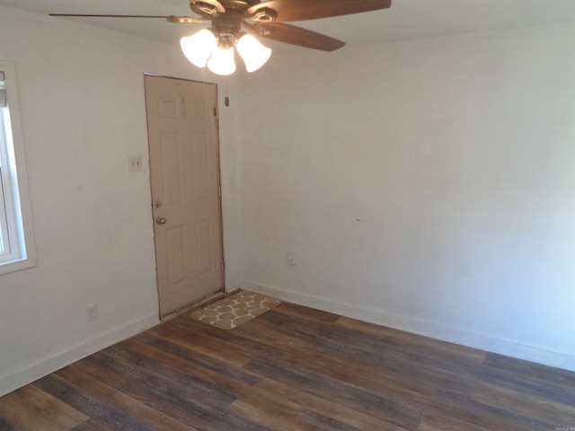 spare room featuring ceiling fan and dark wood-type flooring