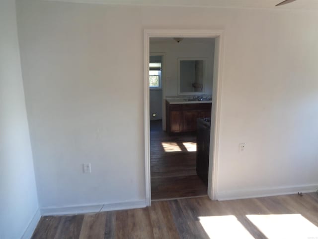 unfurnished room featuring sink and dark hardwood / wood-style flooring