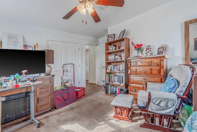 living area with ceiling fan and light carpet