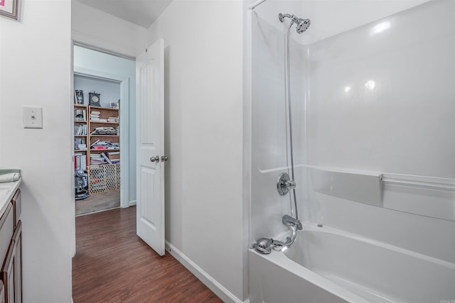 bathroom with vanity, tub / shower combination, and hardwood / wood-style flooring