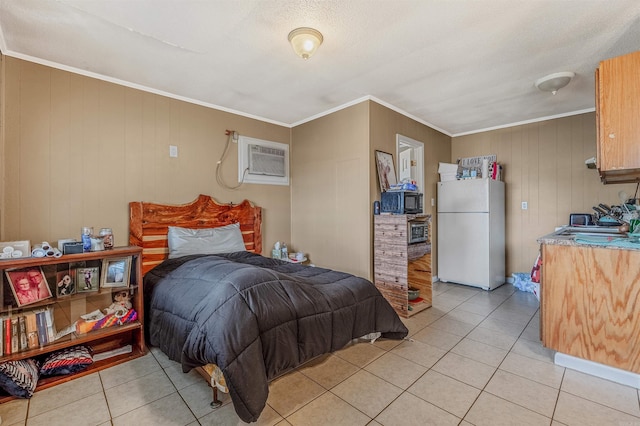 tiled bedroom with a wall mounted AC, wood walls, crown molding, and white fridge