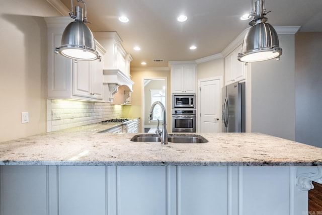 kitchen featuring kitchen peninsula, white cabinets, stainless steel appliances, and ornamental molding