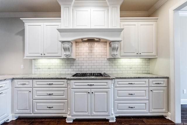 kitchen featuring light stone counters, white cabinets, and stainless steel gas cooktop